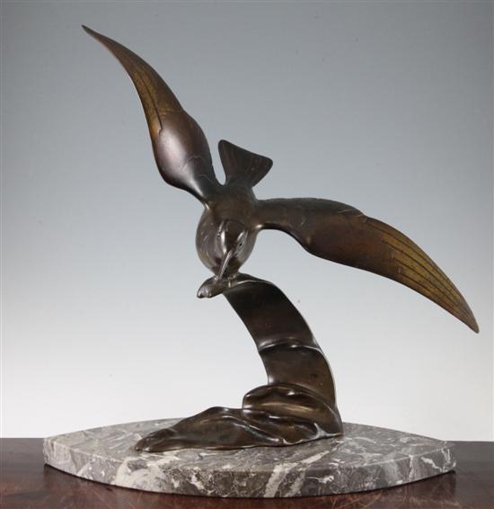 A French Art Deco patinated bronze model of a sea bird on the crest of a wave, 19.5in.